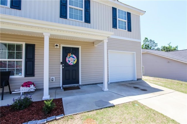 entrance to property with a porch and a garage