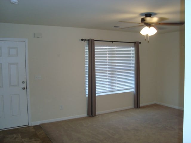 empty room featuring carpet and ceiling fan