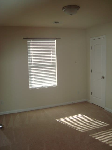 spare room with light colored carpet