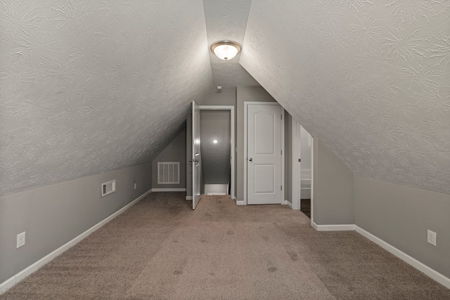 3102 Gatewood Dr, Phenix City, AL 36870 - additional living space with a textured ceiling, lofted ceiling, and carpet floors