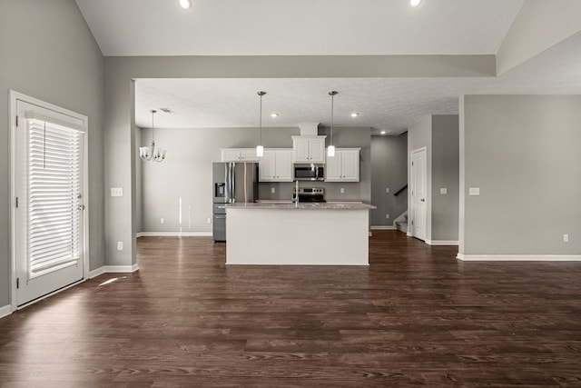 3102 Gatewood Dr, Phenix City, AL 36870 - kitchen featuring appliances with stainless steel finishes, white cabinetry, an island with sink, dark wood-style flooring, and vaulted ceiling