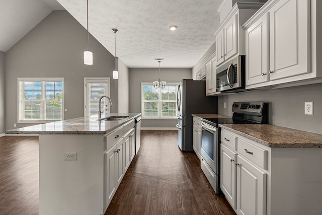 3102 Gatewood Dr, Phenix City, AL 36870 - kitchen featuring appliances with stainless steel finishes, dark wood finished floors, white cabinetry, an island with sink, and vaulted ceiling