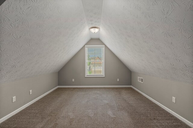 3102 Gatewood Dr, Phenix City, AL 36870 - bonus room with a textured ceiling, vaulted ceiling, and carpet floors
