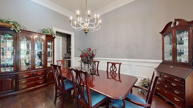 7718 River Crest Dr, Columbus, GA 31904 - dining area featuring a chandelier, ornamental molding, dark wood finished floors, wainscoting, and a decorative wall