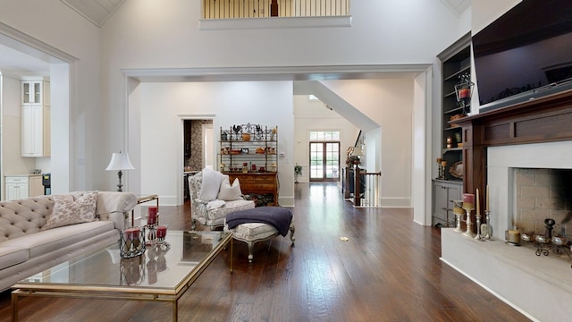 7718 River Crest Dr, Columbus, GA 31904 - living room with dark wood-type flooring, a fireplace with raised hearth, built in features, baseboards, and high vaulted ceiling