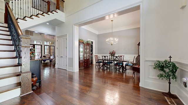 7718 River Crest Dr, Columbus, GA 31904 - entrance foyer with stairway, crown molding, hardwood / wood-style flooring, a chandelier, and a wainscoted wall
