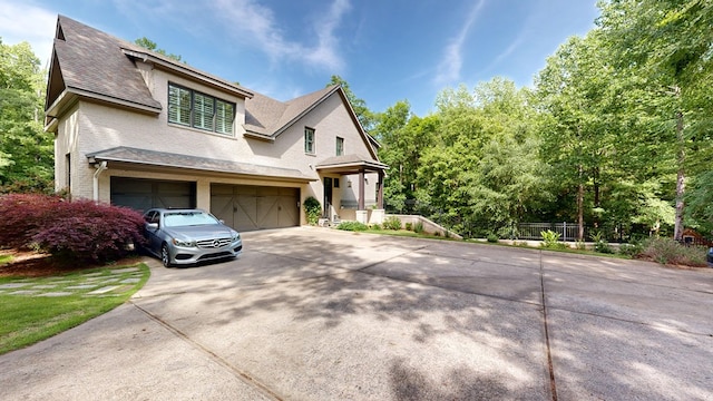 7718 River Crest Dr, Columbus, GA 31904 - view of front of house with driveway, an attached garage, roof with shingles, and stucco siding