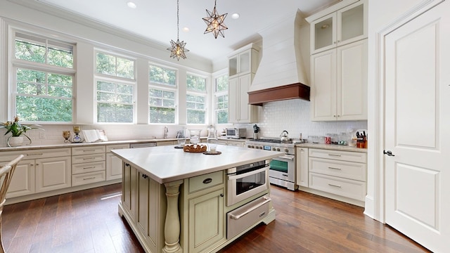 7718 River Crest Dr, Columbus, GA 31904 - kitchen with appliances with stainless steel finishes, custom range hood, a warming drawer, light countertops, and backsplash