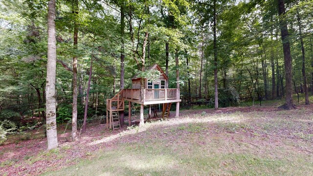 7718 River Crest Dr, Columbus, GA 31904 - view of yard with a deck and a forest view