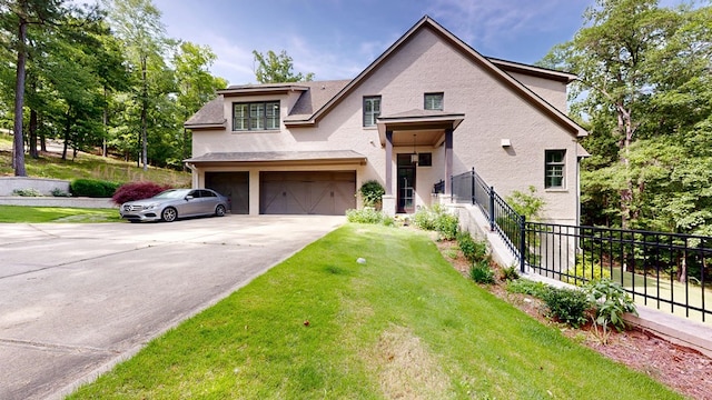 7718 River Crest Dr, Columbus, GA 31904 - view of front facade with an attached garage, driveway, and stucco siding