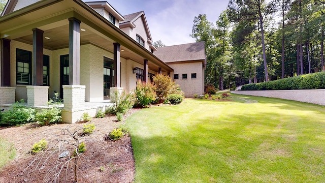 7718 River Crest Dr, Columbus, GA 31904 - view of home's exterior with a lawn, a porch, brick siding, and a shingled roof