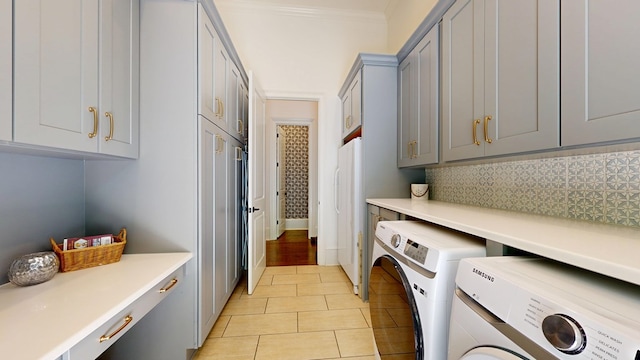 7718 River Crest Dr, Columbus, GA 31904 - washroom with washer and dryer, cabinet space, light tile patterned floors, and ornamental molding