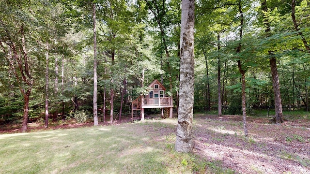 7718 River Crest Dr, Columbus, GA 31904 - view of green lawn featuring a wooden deck and a view of trees