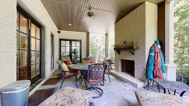7718 River Crest Dr, Columbus, GA 31904 - view of patio with an outdoor brick fireplace and french doors