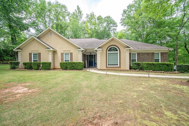 ranch-style home featuring a front yard and stucco siding