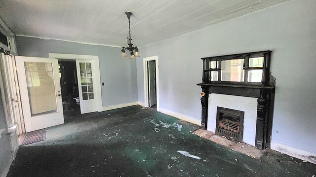 1221 16th Ave, Phenix City, AL 36867 - unfurnished living room with a fireplace, french doors, and a chandelier