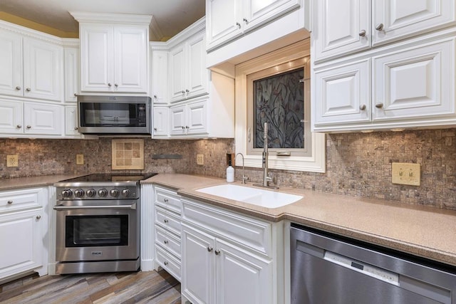 175 Slaughter Dr, Waverly Hall, GA 31831 - kitchen featuring appliances with stainless steel finishes, white cabinets, wood finished floors, and light countertops