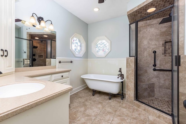 175 Slaughter Dr, Waverly Hall, GA 31831 - bathroom with vanity, a shower stall, a freestanding tub, a wainscoted wall, and recessed lighting
