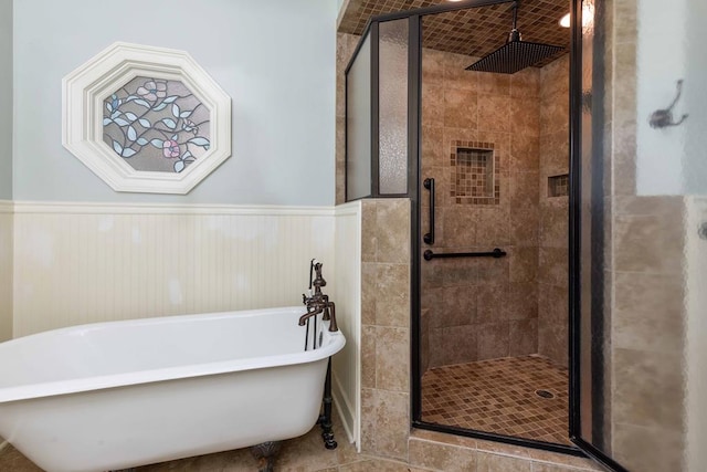 175 Slaughter Dr, Waverly Hall, GA 31831 - bathroom featuring a freestanding bath, a stall shower, a wainscoted wall, and tile patterned floors