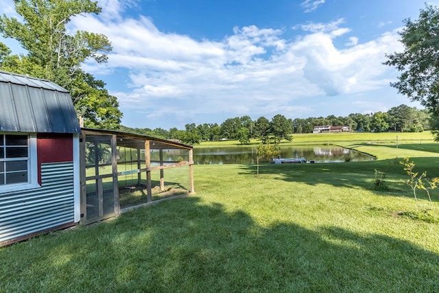 175 Slaughter Dr, Waverly Hall, GA 31831 - view of grassy yard featuring a water view, exterior structure, an outdoor structure, and view of wooded area