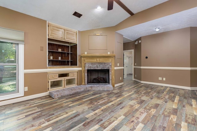 175 Slaughter Dr, Waverly Hall, GA 31831 - unfurnished living room featuring vaulted ceiling, a ceiling fan, wood finished floors, and a fireplace