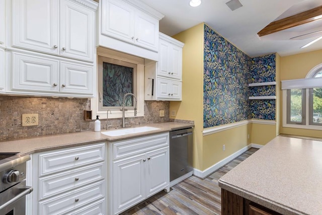175 Slaughter Dr, Waverly Hall, GA 31831 - kitchen with dishwasher, light wood finished floors, light countertops, and white cabinets