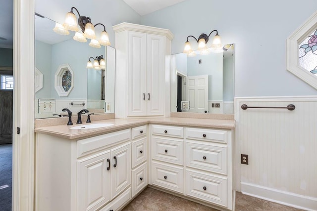 175 Slaughter Dr, Waverly Hall, GA 31831 - bathroom featuring a chandelier, vanity, healthy amount of natural light, wainscoting, and tile patterned floors