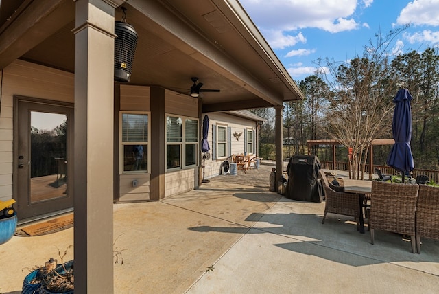 view of patio featuring outdoor dining space, a grill, and ceiling fan