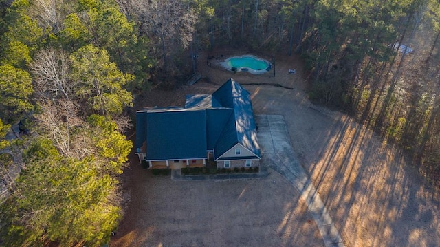 drone / aerial view featuring a forest view