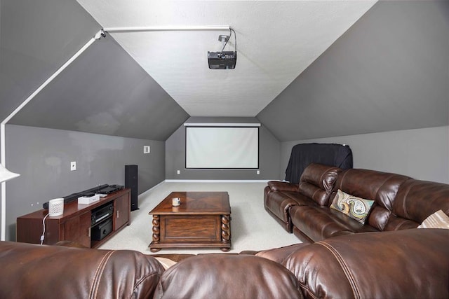 home theater room featuring vaulted ceiling, carpet flooring, and baseboards