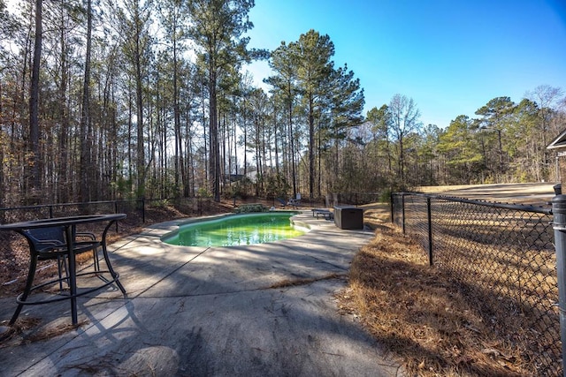 view of swimming pool with a fenced in pool, a patio, and fence