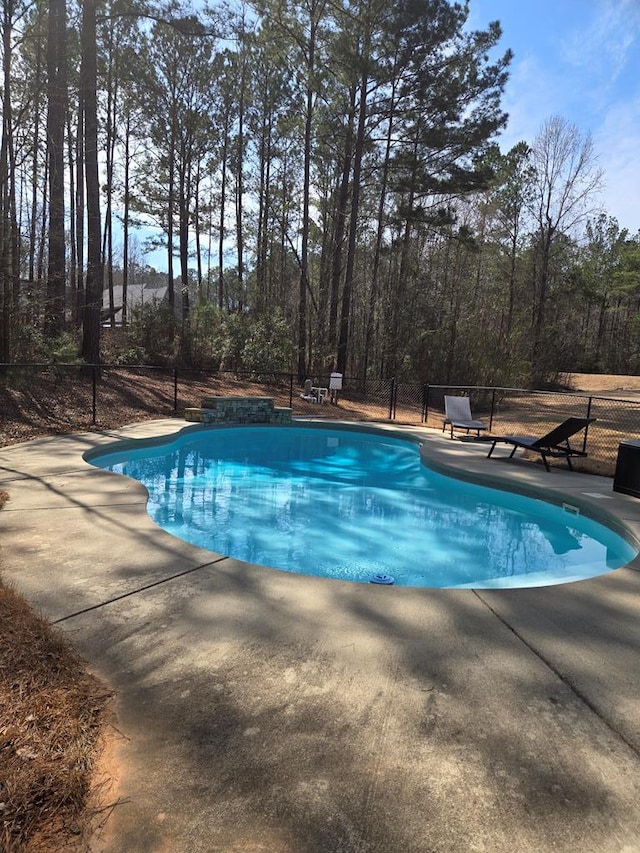 pool featuring a patio and fence