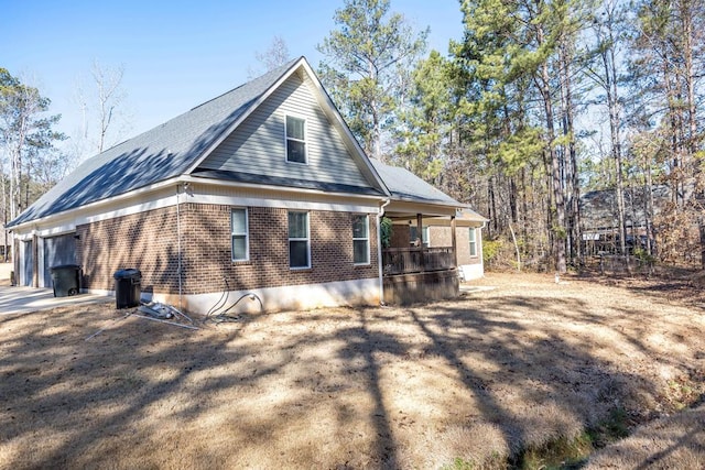 view of home's exterior featuring a garage and brick siding