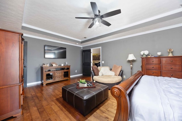 bedroom featuring baseboards, a raised ceiling, ceiling fan, ornamental molding, and hardwood / wood-style floors