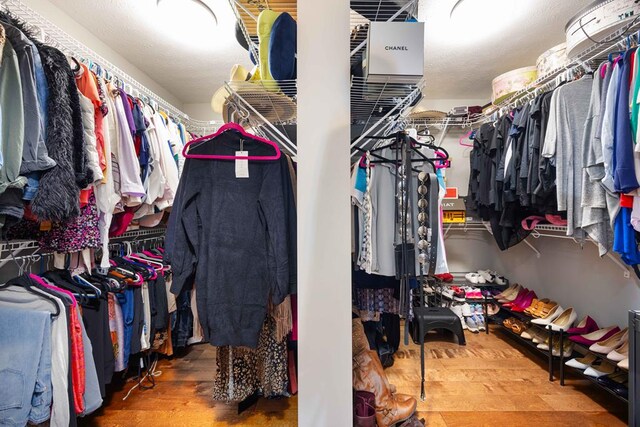 walk in closet with wood finished floors