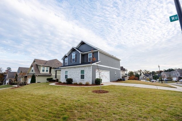 view of front of home with a front lawn and a garage