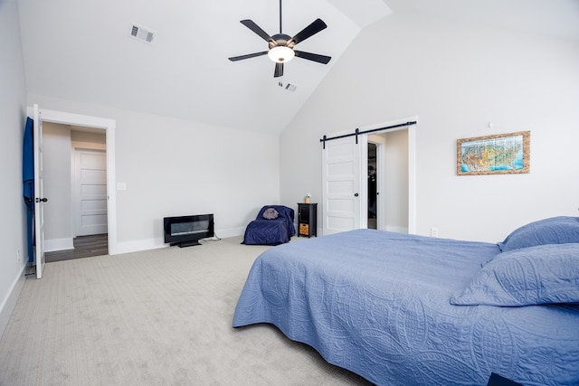 bedroom featuring a barn door, carpet floors, high vaulted ceiling, and ceiling fan