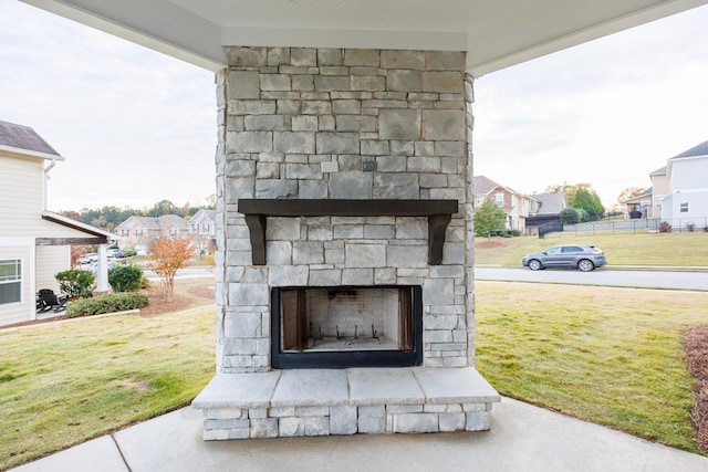 details with an outdoor stone fireplace