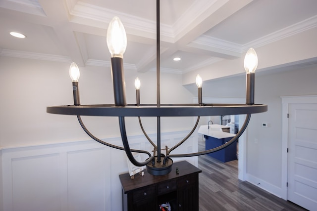 interior details featuring hardwood / wood-style floors, ornamental molding, and beamed ceiling