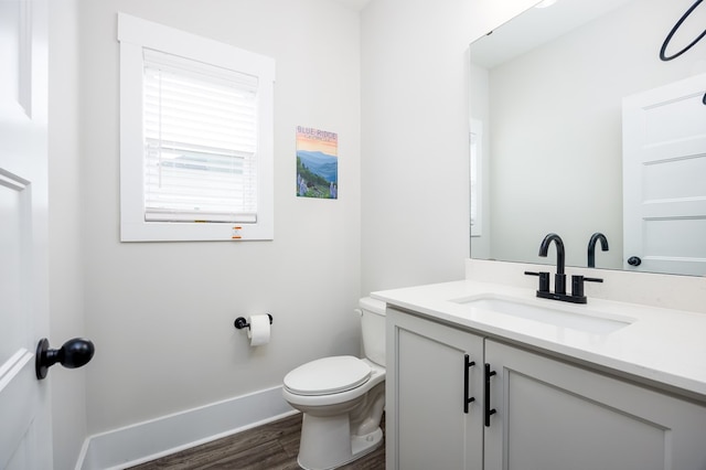 bathroom featuring hardwood / wood-style floors, vanity, and toilet