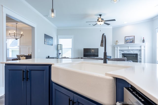 kitchen featuring a healthy amount of sunlight, crown molding, blue cabinets, and a fireplace