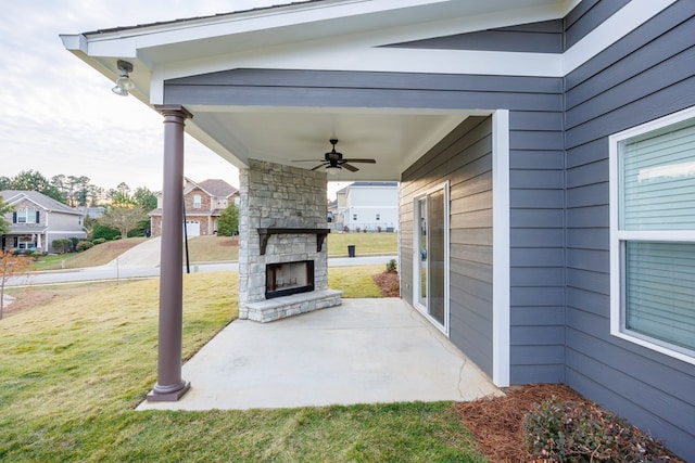 view of patio / terrace with an outdoor stone fireplace and ceiling fan