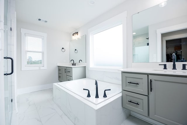 bathroom featuring vanity and independent shower and bath