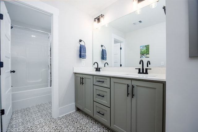 bathroom featuring tile patterned floors, vanity, and bathing tub / shower combination