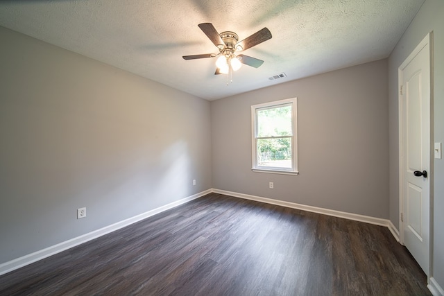 spare room with ceiling fan, dark hardwood / wood-style flooring, and a textured ceiling