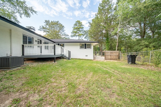 view of yard featuring cooling unit and a deck