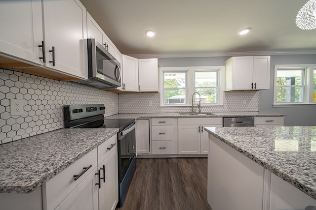 kitchen featuring white cabinetry, sink, stainless steel appliances, dark hardwood / wood-style flooring, and decorative backsplash