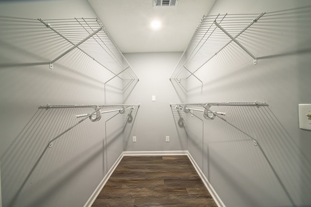 walk in closet featuring dark hardwood / wood-style flooring