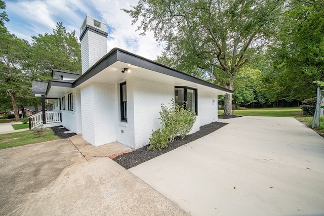 view of side of home with a yard