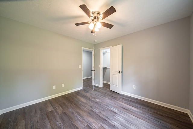 spare room with ceiling fan, dark wood-type flooring, and a textured ceiling